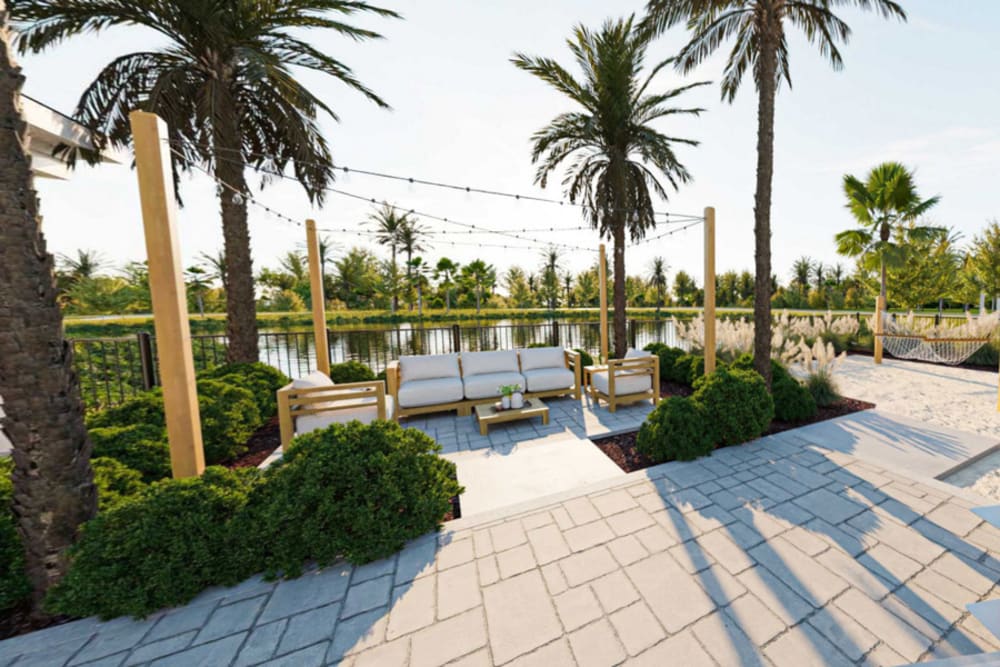 Outdoor lounge space by the lake at Primrose at Santa Rosa Beach in Santa Rosa Beach, Florida