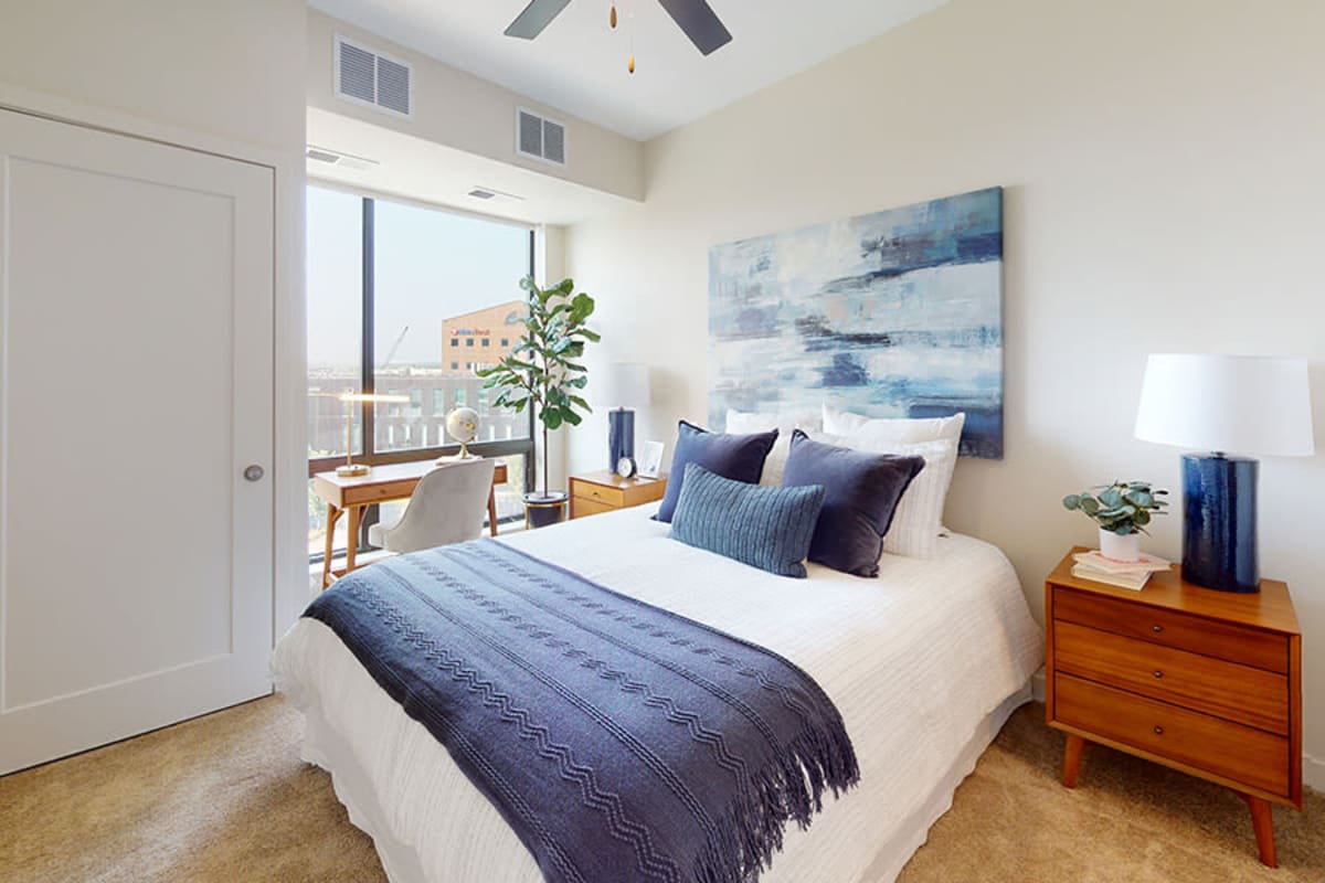 Apartment bedroom with a ceiling fan at Junction Flats in Minneapolis, Minnesota