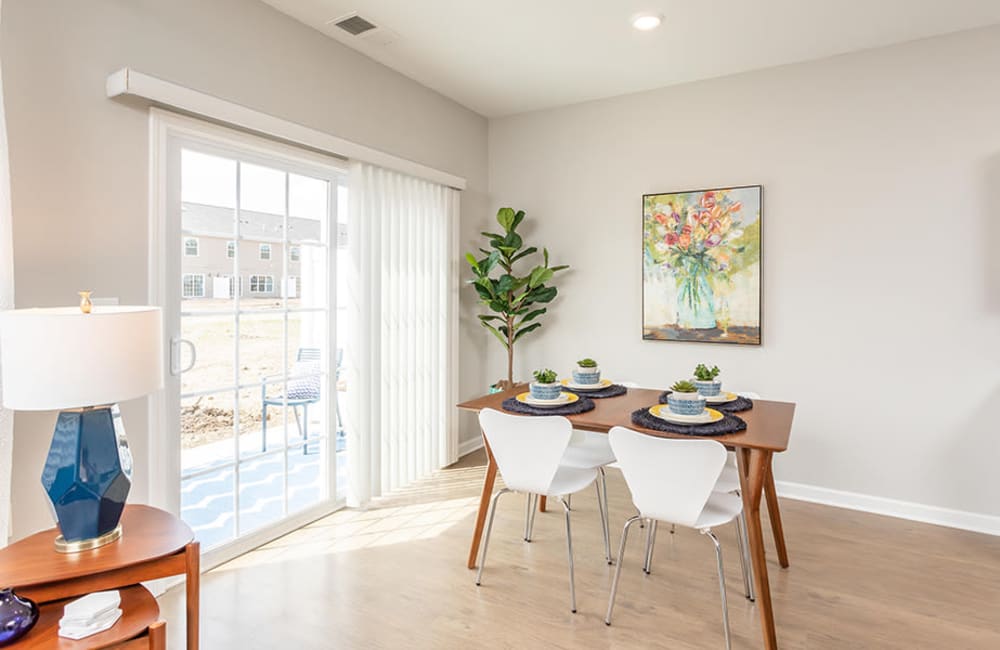 Dinning room with sliding door access to a private patio at Woodland Acres Townhomes in Liverpool, New York