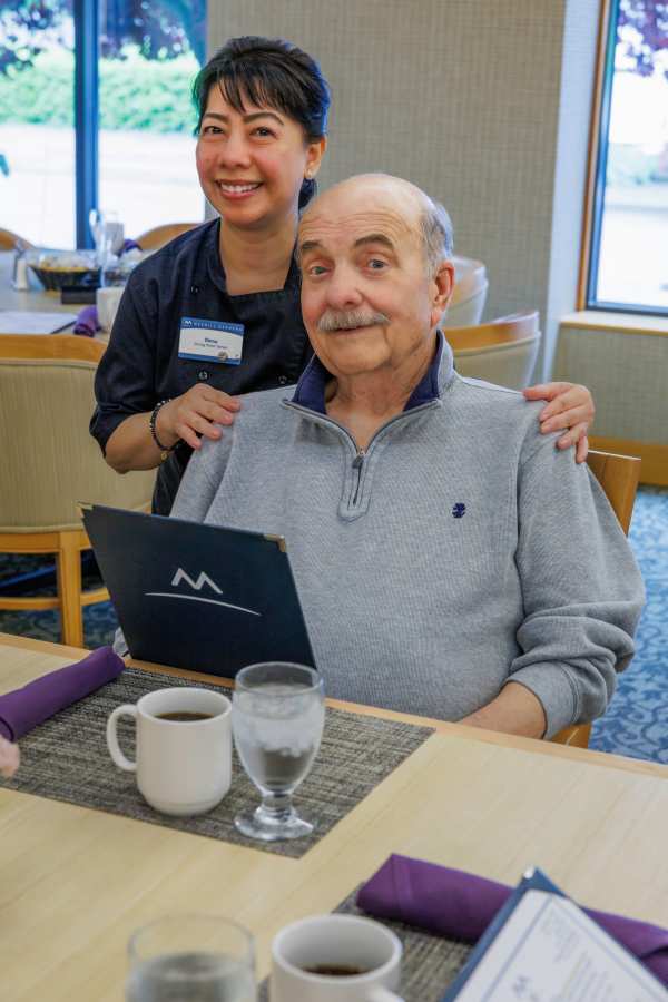 Server helping resident with menu