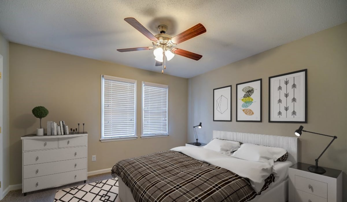 A bedroom with a ceiling fan at Forest Edge Townhomes in Raleigh, North Carolina