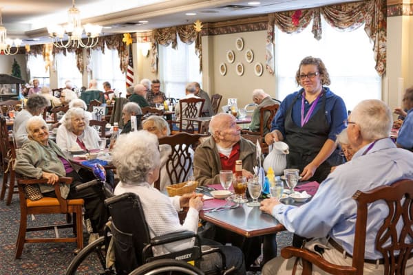 Resident sharing a meal with a friends at The Manor at Market Square in Reading, Pennsylvania