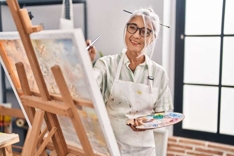Resident in painting class at Reserve at Round Rock in Round Rock, Texas