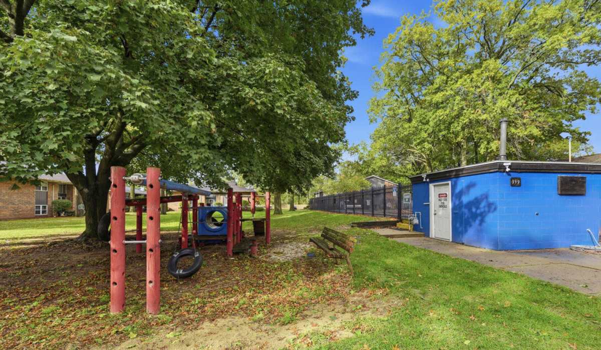 Charming playground surrounded by lush landscaping at The Reserve at Pin Oak Manor Apartments in Mishawaka, Indiana.