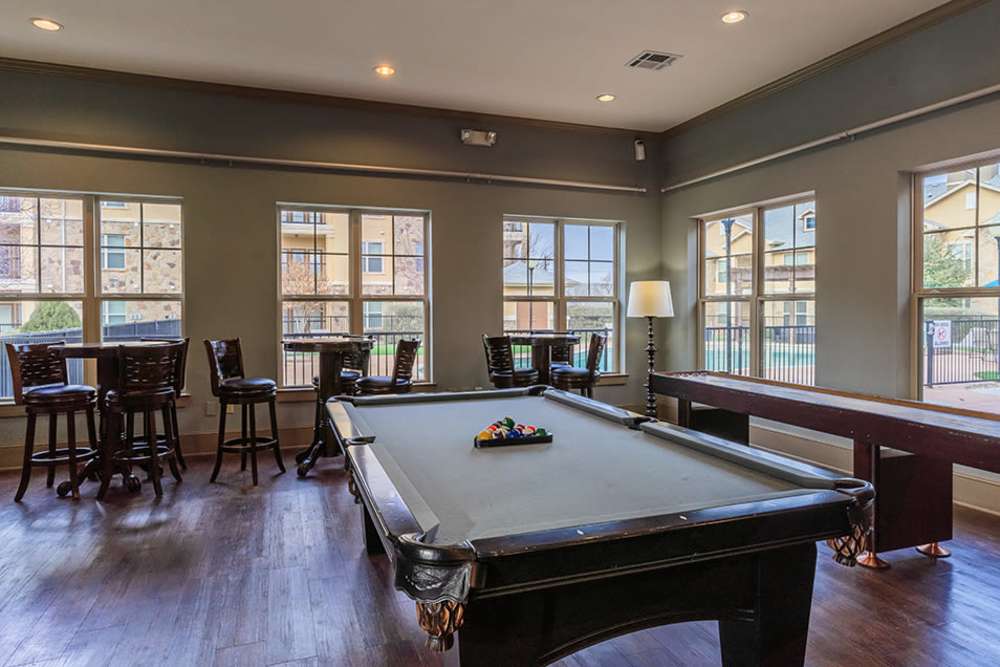 Pool table and seating area in clubhouse at Blue Ridge in Midland, Texas