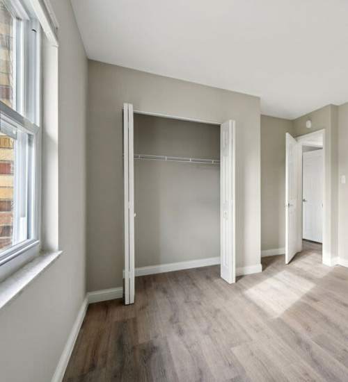 Bedroom with access to closet at Charleston Square Apartments in Columbus, Indiana