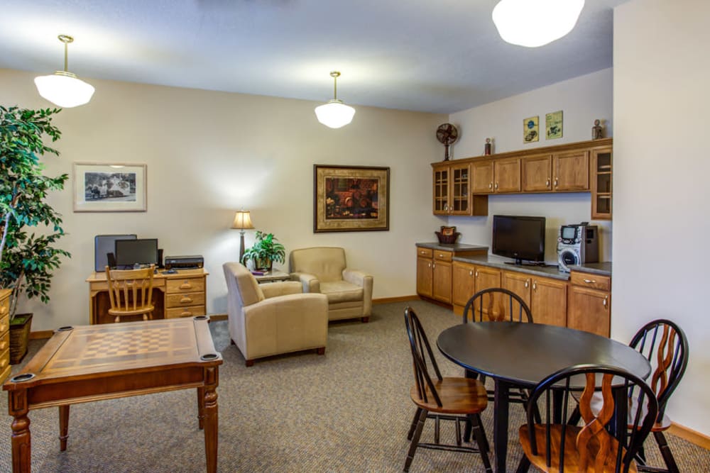 Activity room with TV and computer workstation at Addington Place of Carroll in Carroll, Iowa.