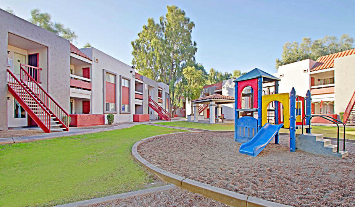On-site amenities like lawn, playground and stairwell access at 544 Southern Apartments in Mesa, Arizona