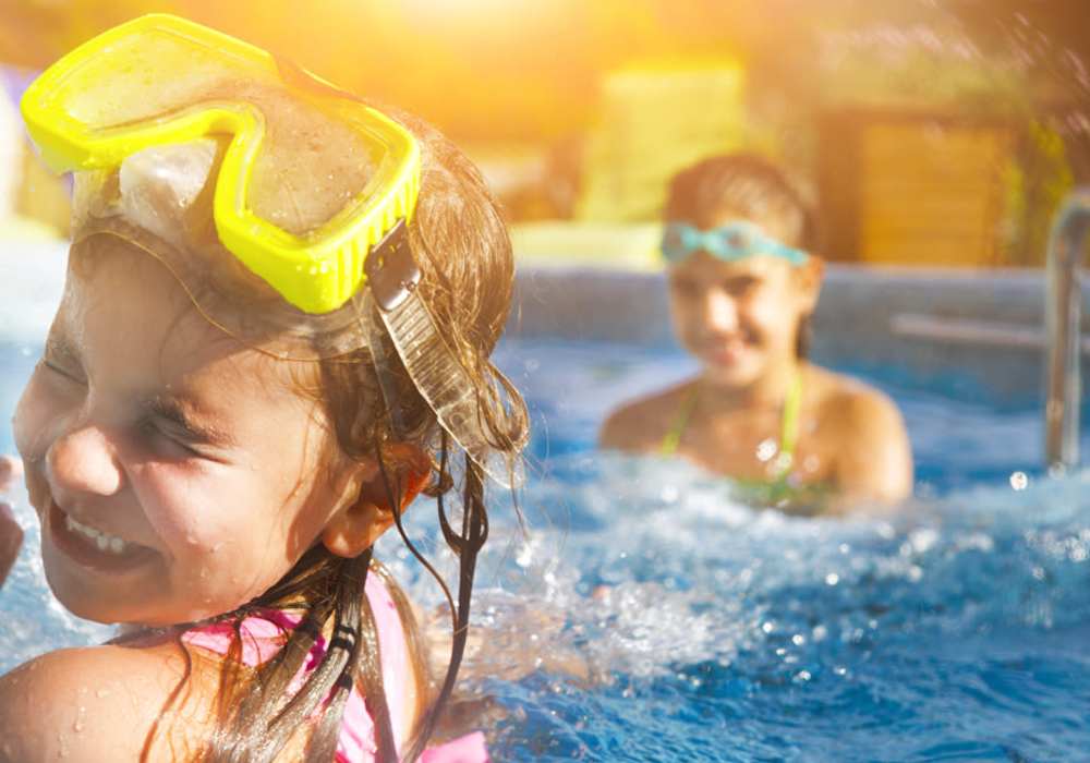 Kids playing and splashing each other in pool at Cobblestone Village in Summerville, South Carolina