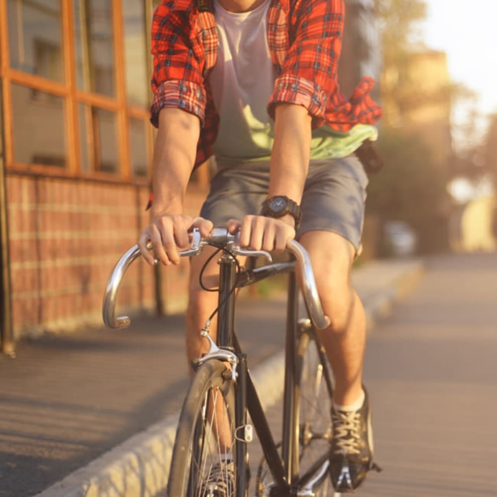 Resident riding bike near Quailwood Apartments in Stockton, California