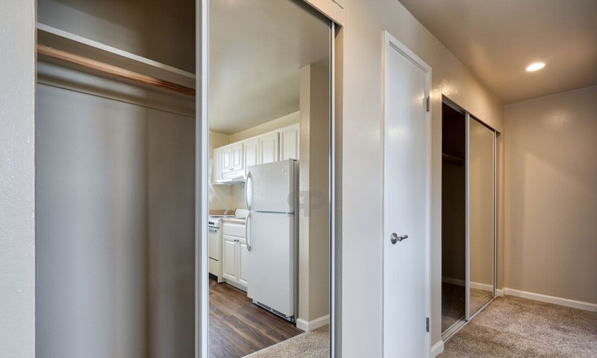 closet and door to a bedroom at Woodmont Apartments in Belmont, California