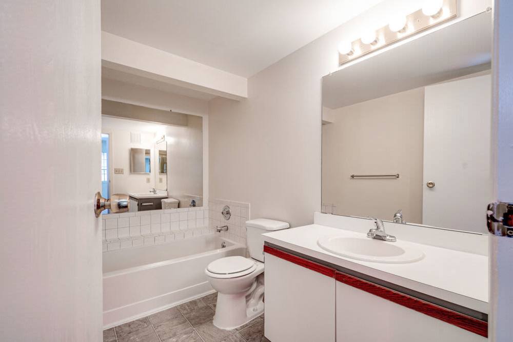 Apartment bathroom with bathtub and storage vanity at Carriage Court in Cincinnati, Ohio