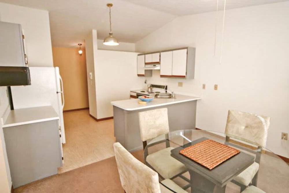 Modern apartment with kitchen and dining space at Carriage Court in Cincinnati, Ohio