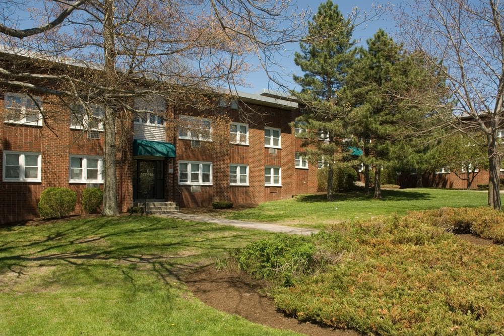 Exterior of Davis Commons surrounded by greenery in Brockton, Massachusetts