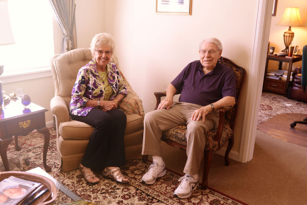 Resident couple sitting in recliner chairs at Quail Park of Lynnwood in Lynnwood, Washington