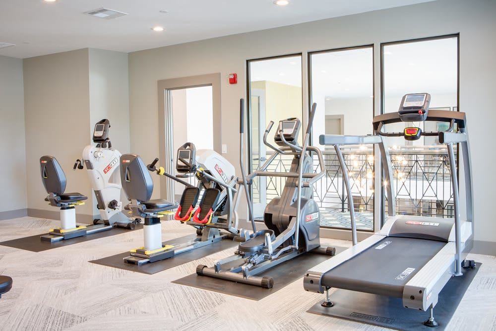 4 exercise machines lined up on wall at The Spring at Silverton in Fort Worth, Texas