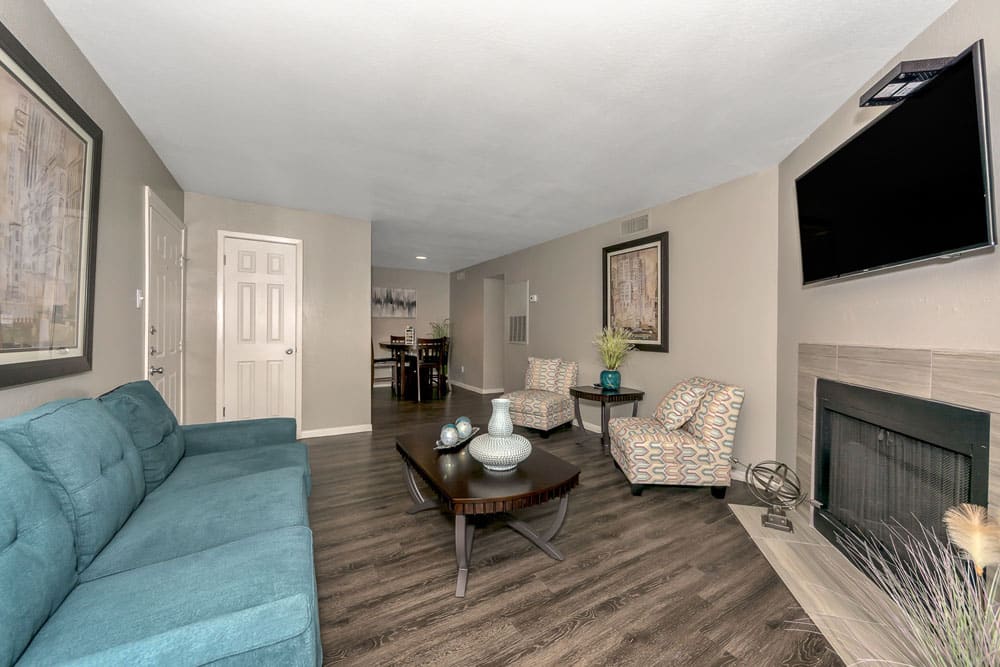 Spacious living room with hardwood style flooring at Pecan Ridge in Waco, Texas