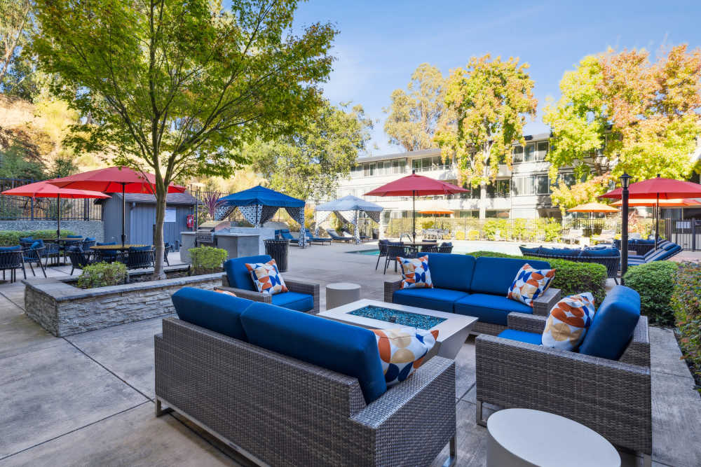 Community lounge seating near swimming pool at Belmont Glen Residences in Belmont, California