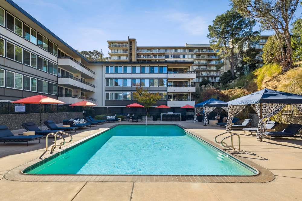 Swimming pool with lounge seating and community view at Belmont Glen Residences in Belmont, California