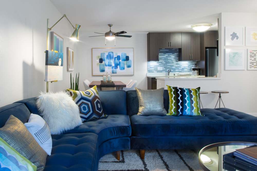 Living room with large sofa and view to kitchen at Belmont Glen Residences in Belmont, California