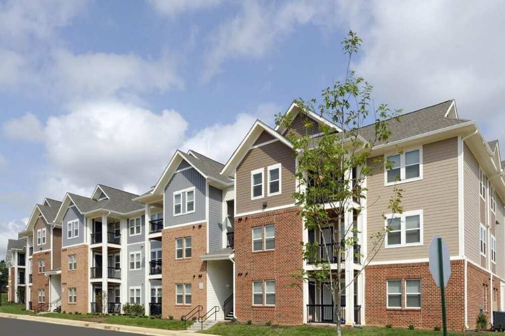 Modern multi-unit apartments with contemporary architecture and landscaped surroundings at Adams Crossing in Waldorf, Maryland