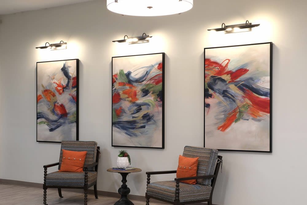 Sitting area with wall art in the clubhouse at Sunny Garden Apartments in La Puente, California