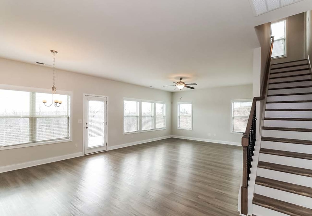 Living space with lots of windows and a staircase at Moss Pointe in Canton, Georgia