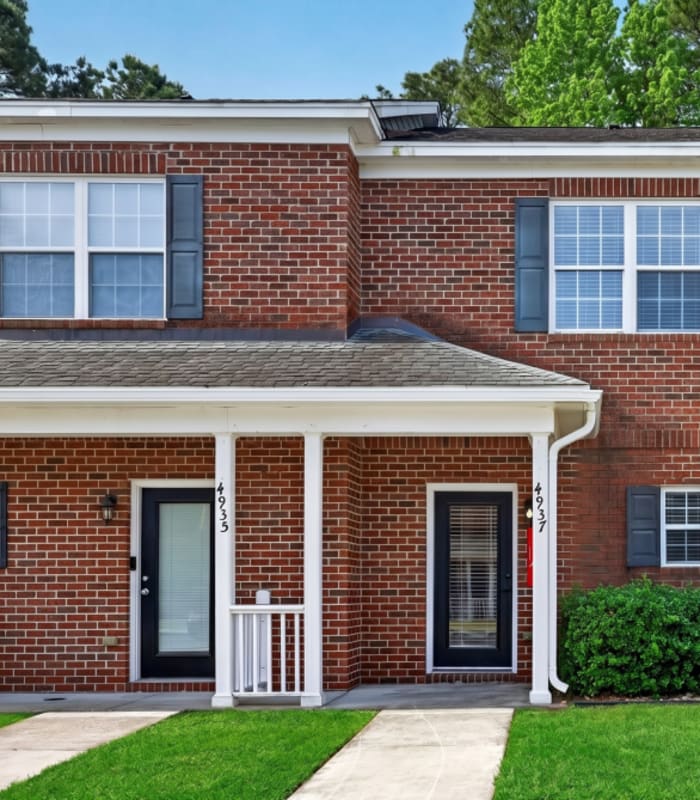 Brick apartment home with front porch at The Townes At Prior in Wilmington, North Carolina