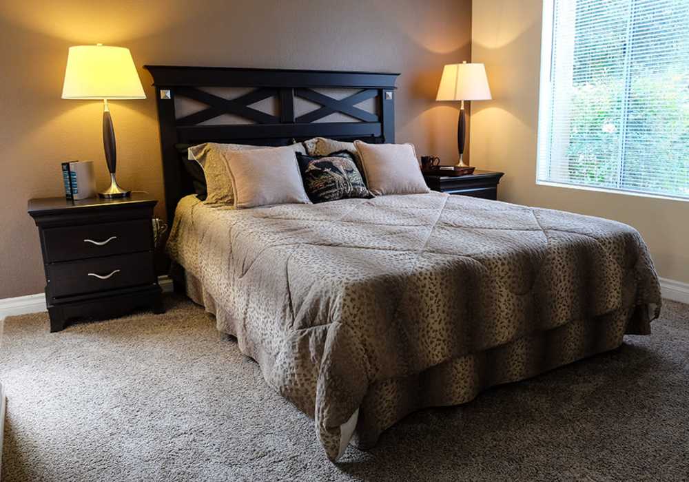 Model bedroom with carpet flooring at Shadowridge Summerwind in Vista, California