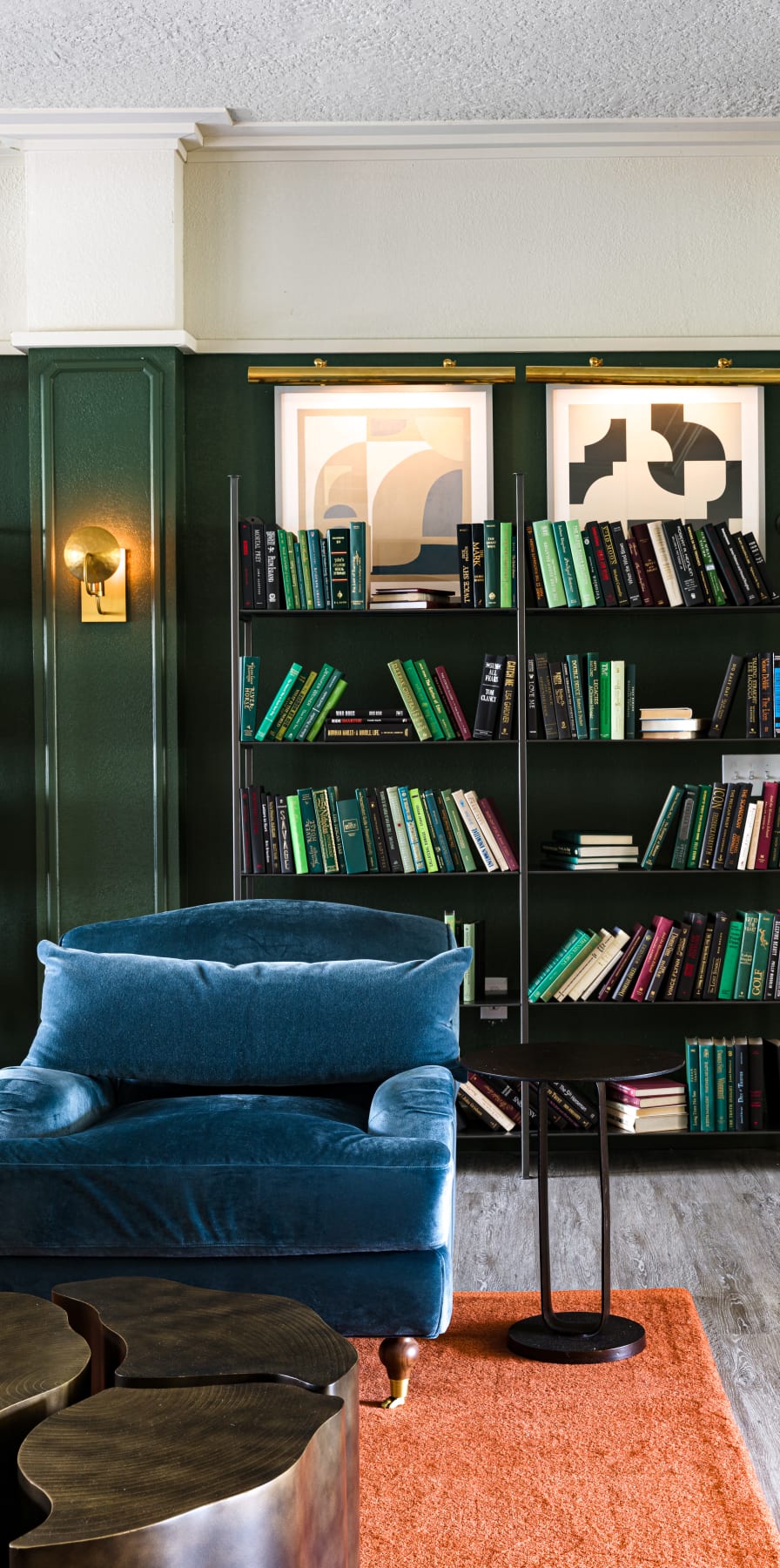 Velvet armchair in front of a bookcase in the clubhouse at 4050 Lofts in Tampa, Florida