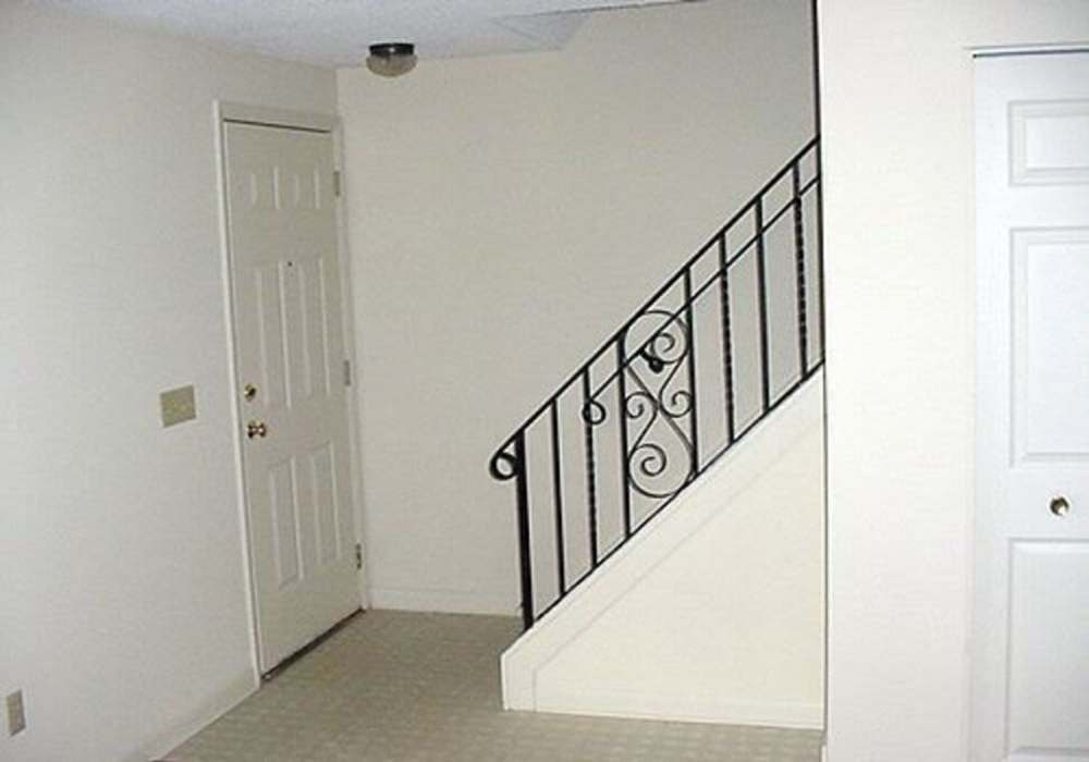 Empty foyer with staircase and doors at Jefferson Manor Townhomes in Fairport, New York