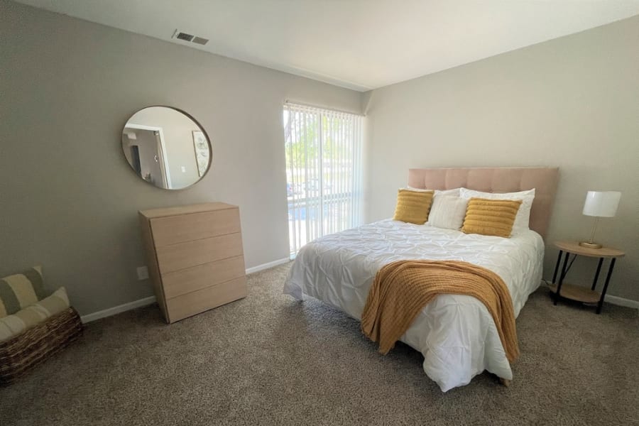 Furnished model apartment bedroom at The Village on Riverwalk in College Park, Georgia