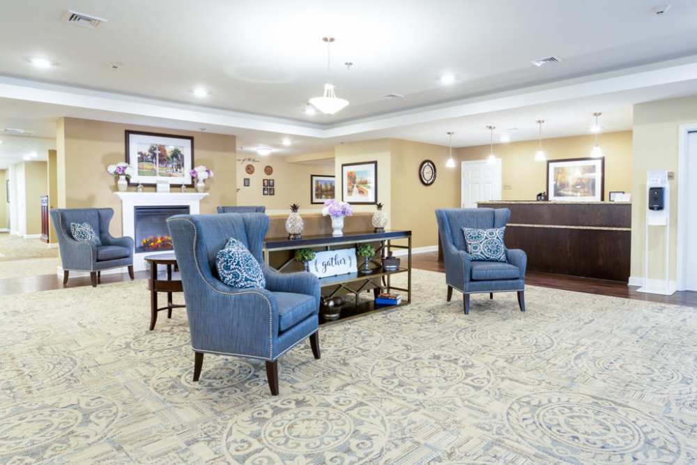 Indoor waiting hall with chairs and tables at The Harmony Collection at Roanoke - Assisted Living in Roanoke, Virginia