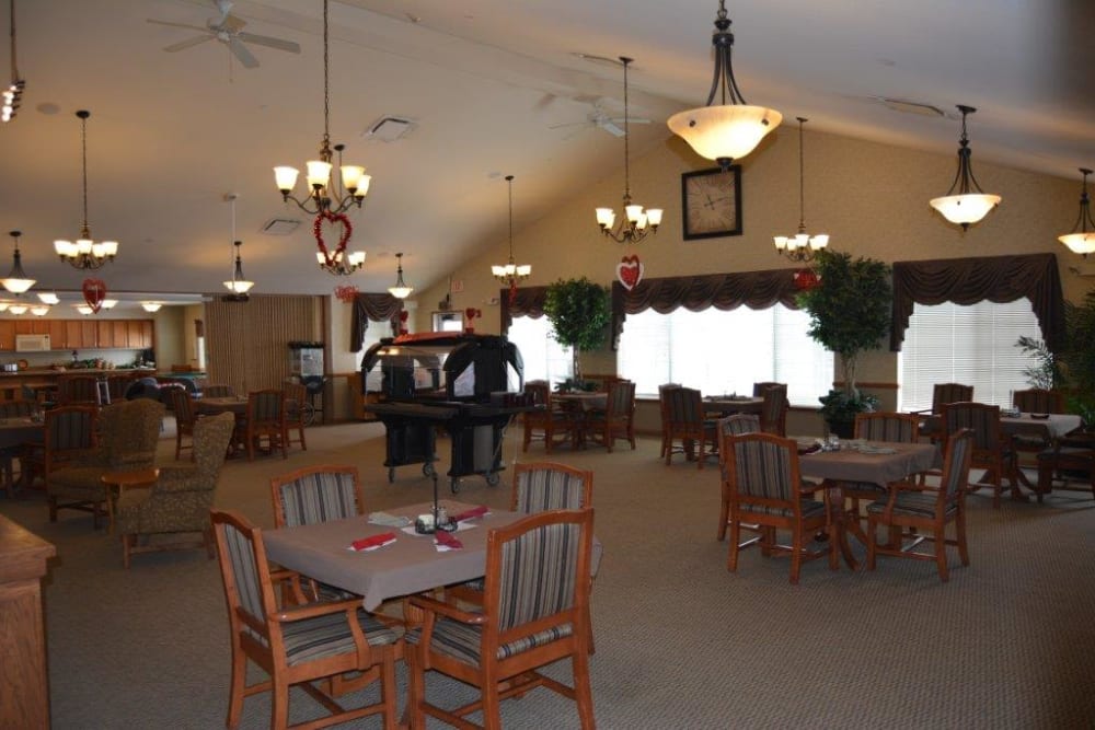Spacious brightly lit resident dining room at Courtyard Estates at Hawthorne Crossing in Bondurant, Iowa.