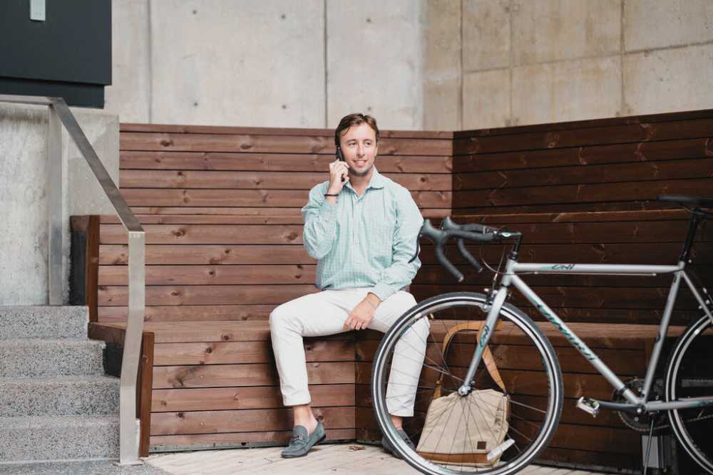 A man talking on the phone with his bike at St. Albans Lofts in Raleigh, North Carolina
