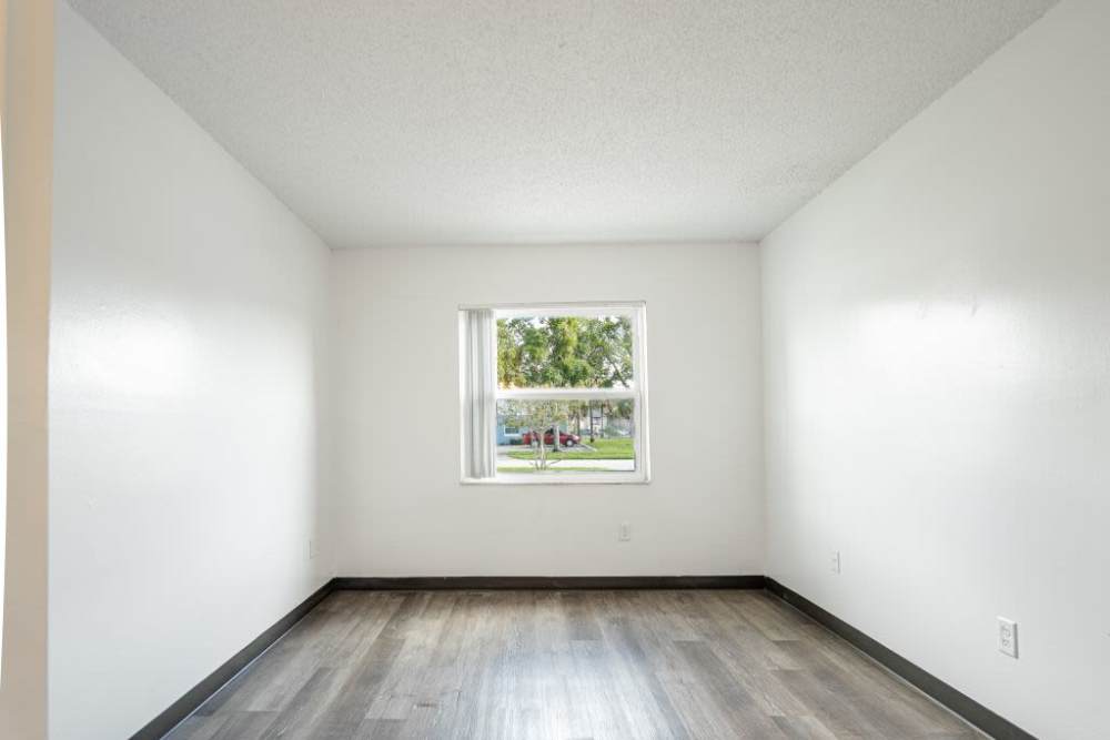 Bedroom with wood flooring and window at Dunwoodie Place in Orlando, Florida