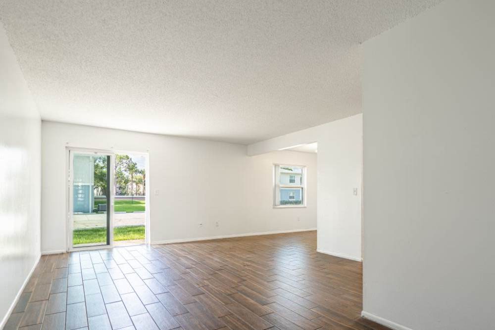 unfurnished living room with large window at Dunwoodie Place in Orlando, Florida