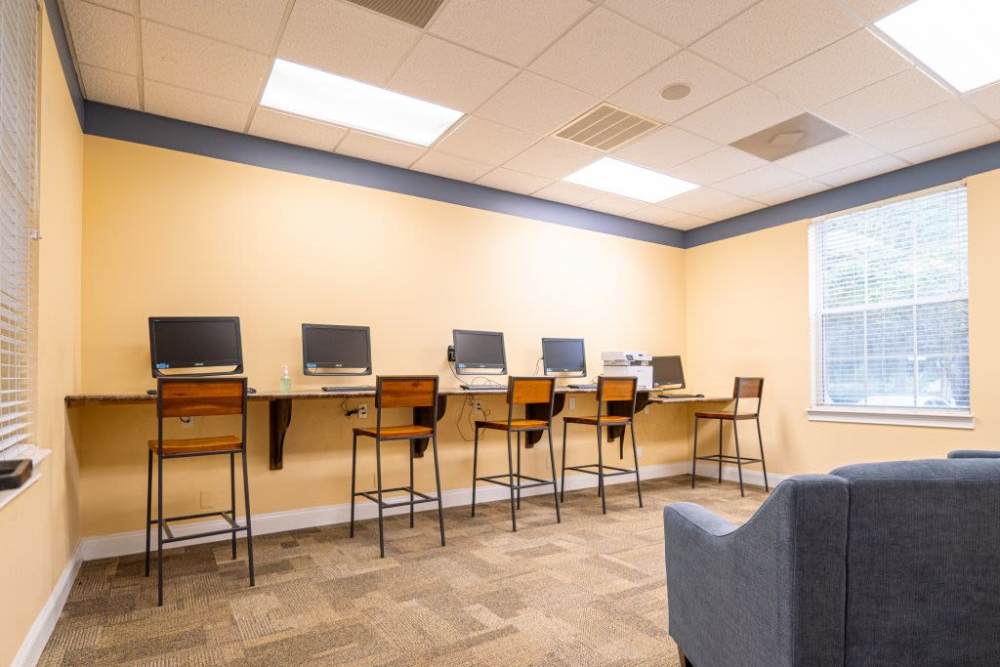 Community leasing office with computers and seating at Logan Heights in Sanford, Florida