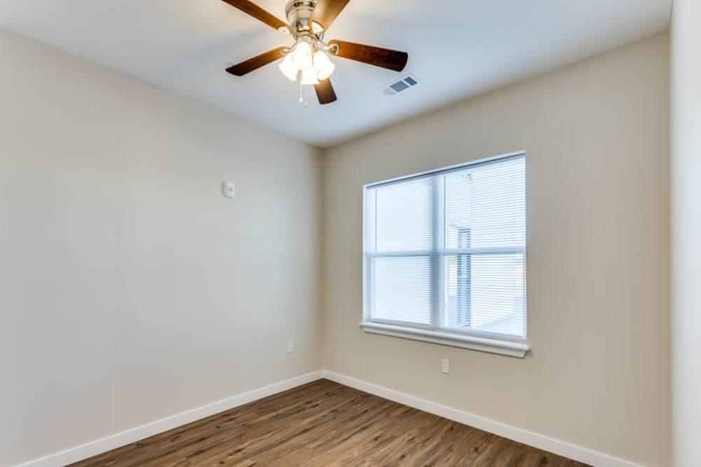 Well-lit room with ceiling fan at The Trail Lakes in Fort Worth, Texas