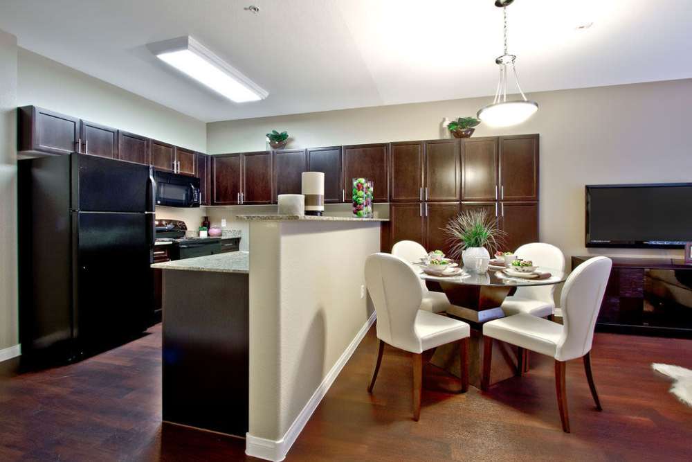 View of dining table with open kitchen at Acapella in Las Vegas, Nevada