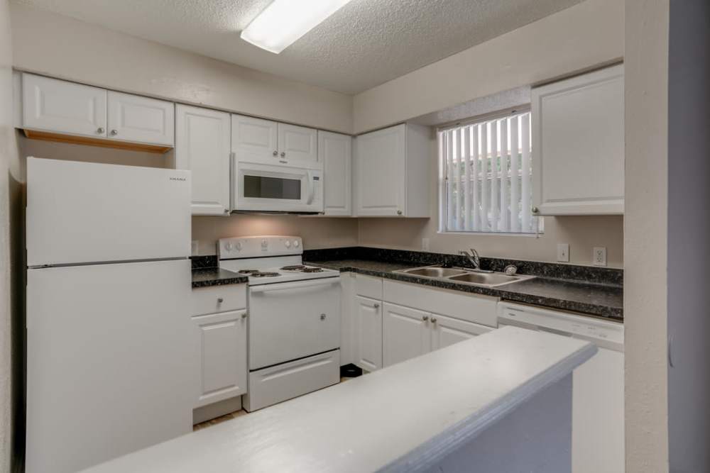Kitchen with wooden cabinets at Dakota San Antonio in San Antonio Texas