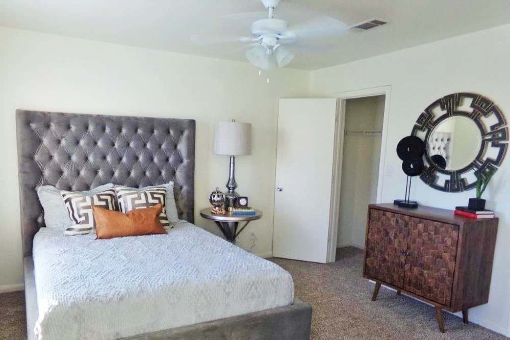 Bright bedroom with large bed and walk-in closet at Woodforest Chase in Houston, Texas