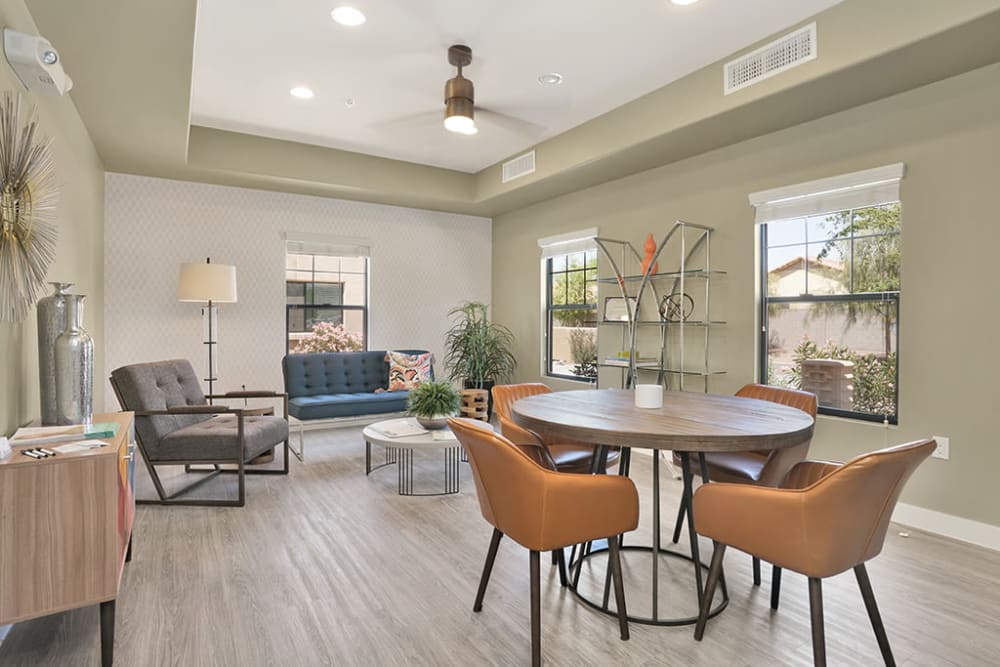 Room with different colored walls with ceiling fan filled with a variation of chairs at Hacienda Del Rey in Litchfield Park, Arizona