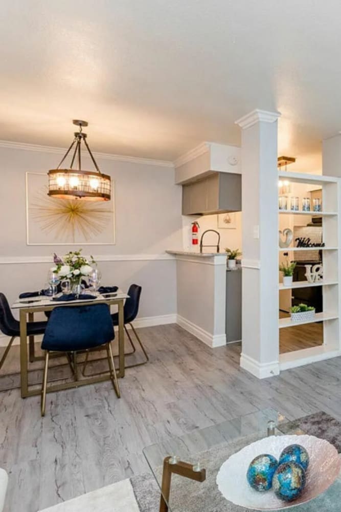 Spacious living room with wood-style flooring and connecting dining space at Ridge Point in Houston, Texas