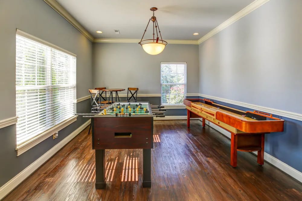 Foosball, shuffleboard and a tall table in the clubhouse at Charleston Pines Apartment Homes in Florence, Kentucky