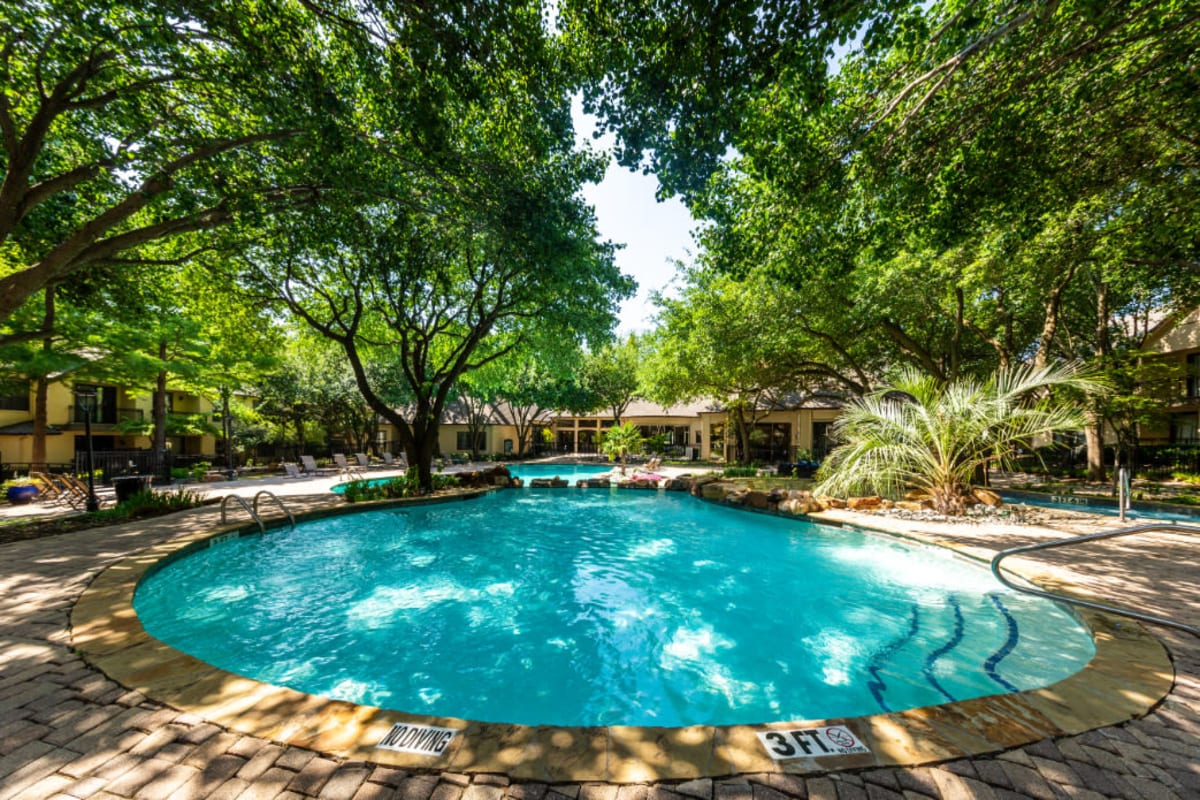 Shallow area of pool sectioned off with rocks at Marquis at Waterview in Richardson, Texas