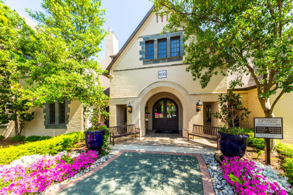 Leasing office main entrance with paved path and flowers along sides at Marquis at Waterview in Richardson, Texas