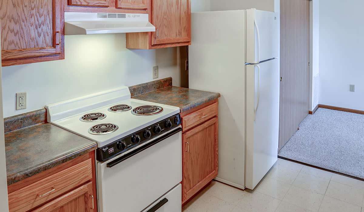 A kitchen with sleek white appliances at Heritage Greene in Washington Court House, Ohio
