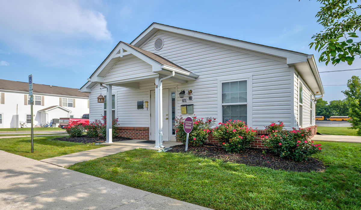 Charming exterior view of the apartment home with green lawn at Webster Greene in Peebles, Ohio