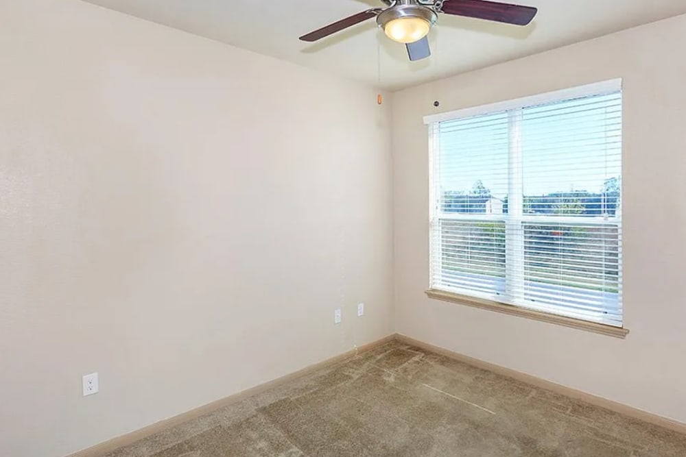 Garden Style bedroom with ceiling fan at Villas On Independence in Port Lavaca, Texas
